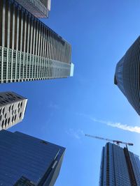 Low angle view of modern buildings against clear blue sky