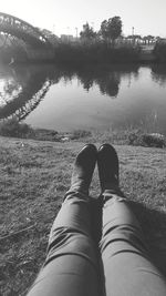 Low section of person on lake against plants