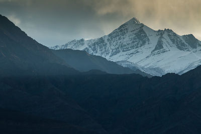 Scenic view of snowcapped mountains against sky