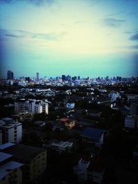 Cityscape against cloudy sky