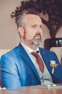 Close-up of mature bridegroom at table