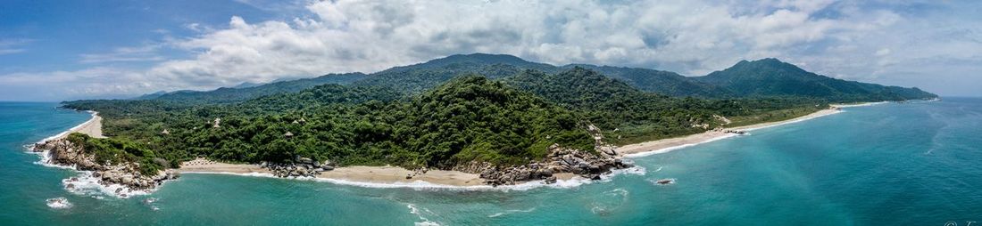 Panoramic view of sea and mountains against sky