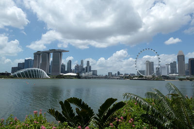 View of city buildings against cloudy sky