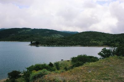 Scenic view of lake and mountains against sky