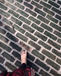 Low section of woman on tiled floor