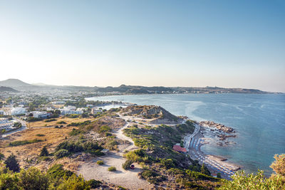 High angle view of sea and mountains against clear sky