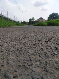 Surface level of road on field against sky