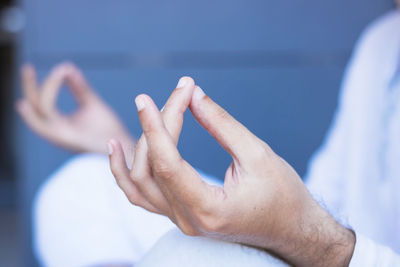 Midsection of man sitting in lotus position