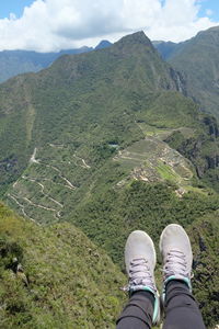 Low section of person standing on mountain