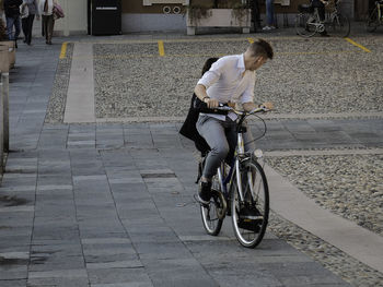 Man riding bicycle on road