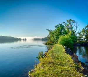 Scenic view of lake against blue sky