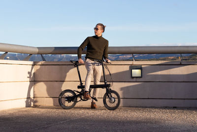 Young man moving around with an electric bicycle to be eco sustaiable and avoid transport pollution 