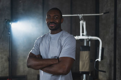 Portrait of young man standing in gym