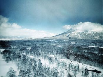 Scenic view of mountains against cloudy sky