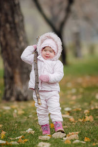 Portrait of cute girl standing on field