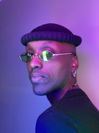 Portrait of young man against blue background