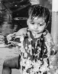 Girl playing in water from sprinkler