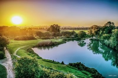 Scenic view of lake against sky during sunset