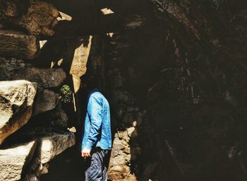 Rear view of a woman walking on rock