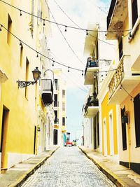 Road amidst buildings in city