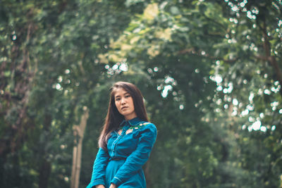 Portrait of a beautiful young woman in forest