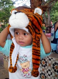 Cute baby girl on rock in park