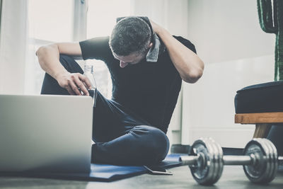 Sporty man working out and trains at home. fit male doing exercise. wellness, health, sport concept