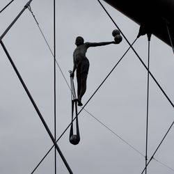 Low angle view of man walking against clear sky