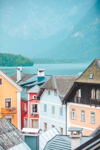 Houses by sea against sky