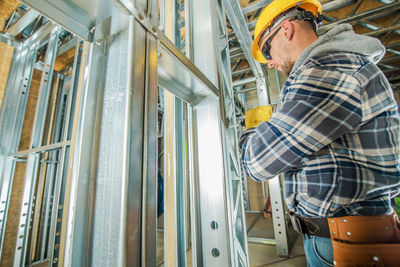 Rear view of man working at construction site