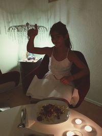 Woman sitting on table in front of restaurant