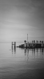 People by sea on pier
