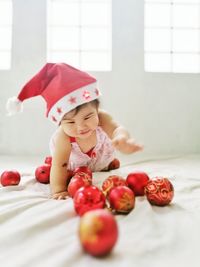 Baby girl with christmas baubles