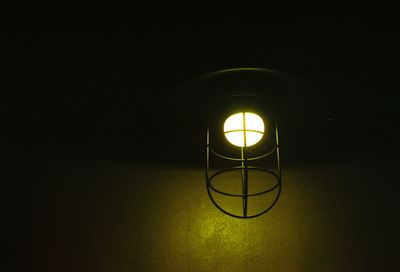 Close-up of illuminated light bulb in darkroom