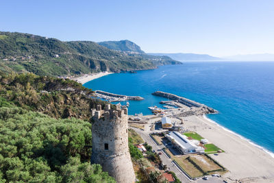 High angle view of sea and mountains against clear sky