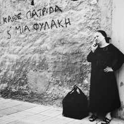 Woman standing against wall