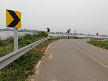 Road sign against clear sky