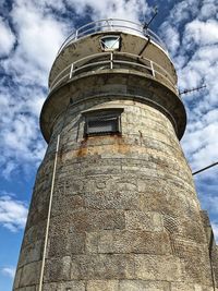 Low angle view of water tower against sky