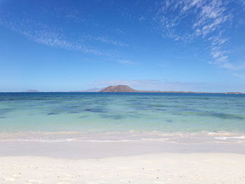 Scenic view of sea against blue sky