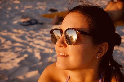 Portrait of woman wearing sunglasses at beach