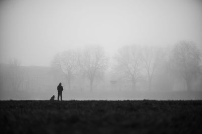 Man standing on field against sky