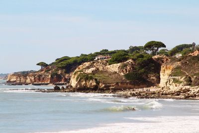 Scenic view of beach against clear sky