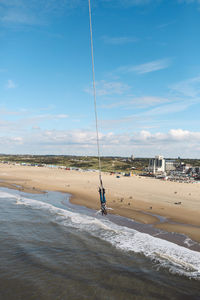 Woman enjoying bungee jumping at beach