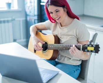 Young woman playing guitar