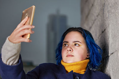 Portrait of young woman using mobile phone