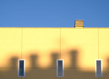 Low angle view of building against clear blue sky