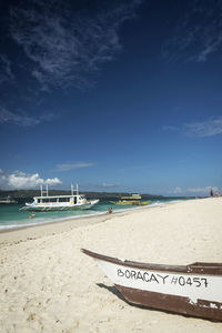 Scenic view of beach against blue sky