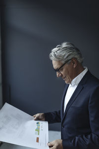 Senior businessman looking at papers