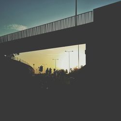 Silhouette bridge against sky during sunset