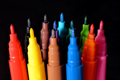 Close-up of multi colored pencils against black background